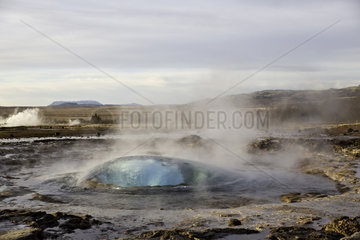 Strokkur  fountain geyser in the geothermal area beside the Hvítá River  east of Reykjavík  Iceland
