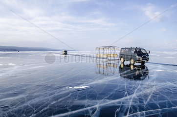 Cars on ice on the surface of Lake Baikal  Siberia  Russia