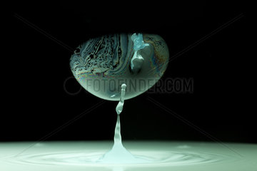 Colorful water drop and soap bubble on black background