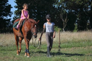 Young Rider walking a girl riding - France