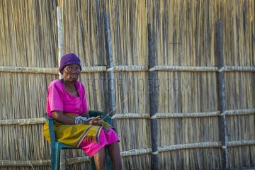 Woman sitting in a village - Okavango Delta Botswana