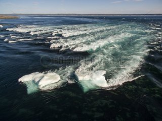 Aerial view of iceberg grounded in shallow rapids during tidal rip in Wager Bay on summer morning  Ukkusiksalik National Park  Nunavut Territory  Canada