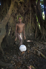 Boy playing with a balloon in forest - Tanna Vanuatu