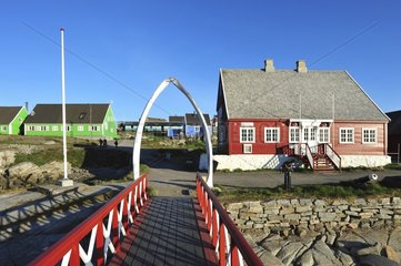 Denmark. Greenland. West coast. Disko Island. The harbour of the village of Qeqertarsuaq  former whale hunting station as shown by the door made of whale bones at the entrance of the village.
