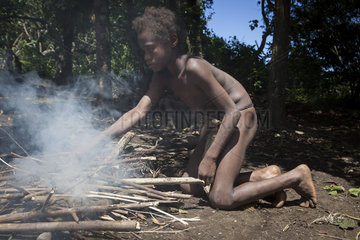 Boy doing fire in his village - Tanna Vanuatu