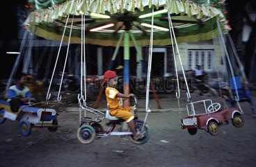 Children on a merry-go-round Myanmar