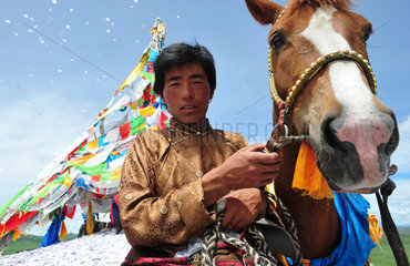 Rider praying before the race when Lapsté - Tibet China