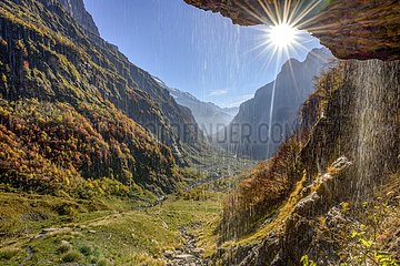 The meandering Giffre - Cirque du Fer à Cheval  shooting behind a waterfall overlooking the Bout du Monde - Nature Reserve Sixt Fer a Cheval   Haute-Savoie   Alps  France