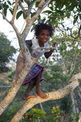 Girl playing in a tree - Tanna Island Vanuatu