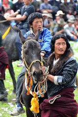 Rider getting ready for a race at the Lapste - Tibet China