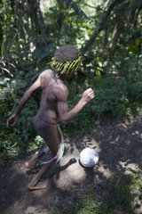 Boy playing with a ball in forest - Tanna Vanuatu