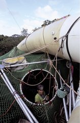 Scientist in blimp-borne inflatable raft on canopy Panama