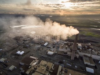 Aerial view of smoke pouring from tall stack at massive industrial facility at Vale Inco Manitoba nickel smelter and mine  Thompson  Manitoba  Canada