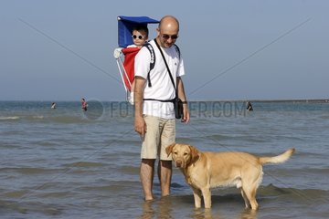 Labrador and his owner at the seaside Normandy France