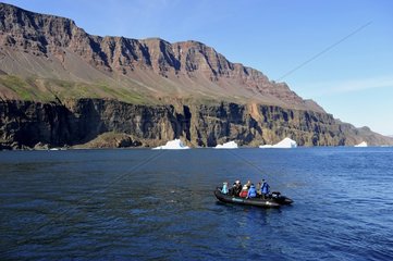 Denmark. Greenland. West coast. Zodiac from a boat cruise near the cliffs of Disko island near the village of Qeqertarsuaq.
