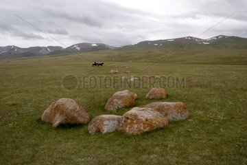Two Nomadic horsemen on a tableland Kyrgyzstan