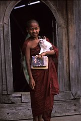 Young monk carrying a cat Burma