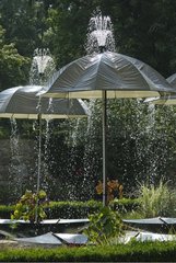 Umbrellas under watering in a garden France