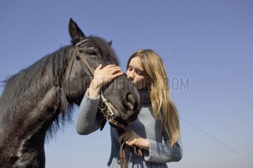Teenager enlacing her Merens Horse's head France