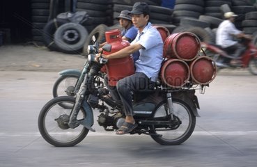 Man transporting gas bottles on his motorbike Vietnam