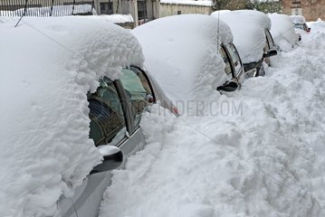 Vehicles buried under snow street downtown France