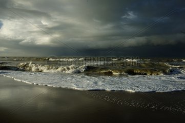 Storm on the beach with laying down sun France
