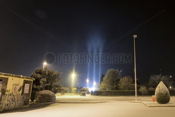 Light pillars in winter  Thyez  Alps  France. In an icy atmosphere (-7 Â° C)  artificial light in the town of Thyez is reflected in ice crystals suspended in the air. This phenomenon known as light pillars is common in the far north but rare in our latitudes.