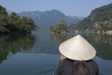 Young woman seen from behind with a conical hat  Lake Ba Be  Vietnam