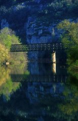 Bridge and its reflection in the river blue France