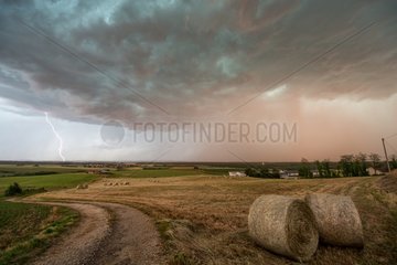 Thunderstorm and lightning above the evening countryside - France