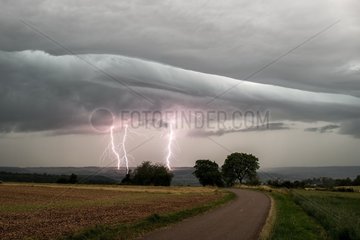 Thunderstorm and lightning above the countryside in summer - France