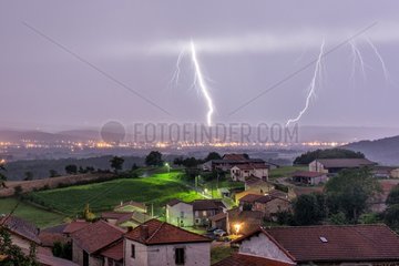 Thunderstorm and lightning above a village in summer - France