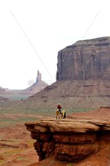 Navajo rider on rock overhang - Monument Valley Utah