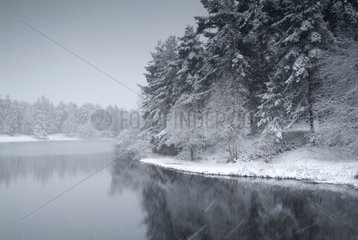 Snow shower on a lake in Auvergne France