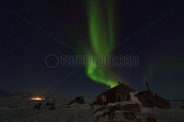 Village of Unarteq  lightened Ittoqqortoormiit in the background  Greenland  February 2016