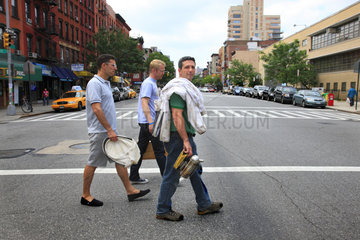 Urban Beekeeping - Andrew Cote beekeeper  founder of the New York City Beekeepers? Association  Adam Johnson  a novice  and Troy Seidman  a curious friend  go on foot to inspect the hives in the apiaries in East Village in New York. USA