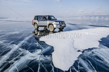 Car on ice on the surface of Lake Baikal  Siberia  Russia