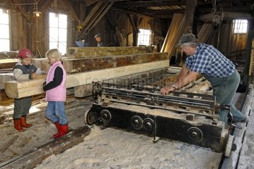 Sawyer and children in a sawmill in Haut-fer -Vosges France