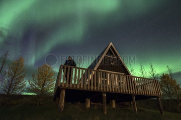 Northern Lights and typical chalet in Egilsstaðir - Iceland