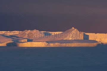 Sunset on icebergs Adelie Land Antarctica