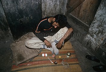Indian drug addict passed out with needle still in his arm