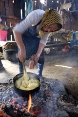 Woman preparing the polenta in a shepfold Romania