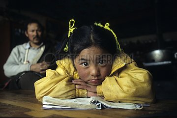 Young Tibetan girl doing her homeworks Xiewu Area of Kham