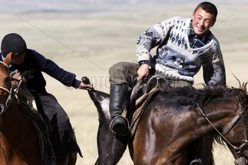 Nomadic horsemen playing in a meadow in Kyrgyzstan