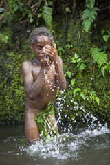 Boy bathing in a river - Tanna Vanuatu