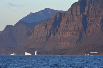 Denmark. Greenland. West coast. Icebergs and mountain in the straight of Vaigat.