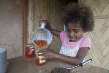 Girl preparing papaya jam - Tanna island Vanuatu