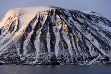 Snow-covered mountain on the coast of North Norway