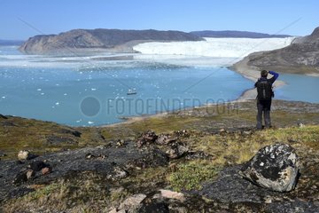 Denmark. Greenland. West coast. Tourists looking at the bay of Quervain with the glaciar Eqip Sermia at Port Victor  camp of Paul-EMile Victor  chef of the French polar expeditions which studied the Greenland ice cap from 1948 and 1953.