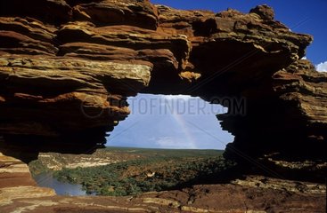 Fenêtre naturelle dans la roche et arc-en-ciel Australie